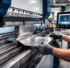 APB technician operating CNC press brake machine forming stainless steel plate at Fort Lauderdale marine fabrication shop